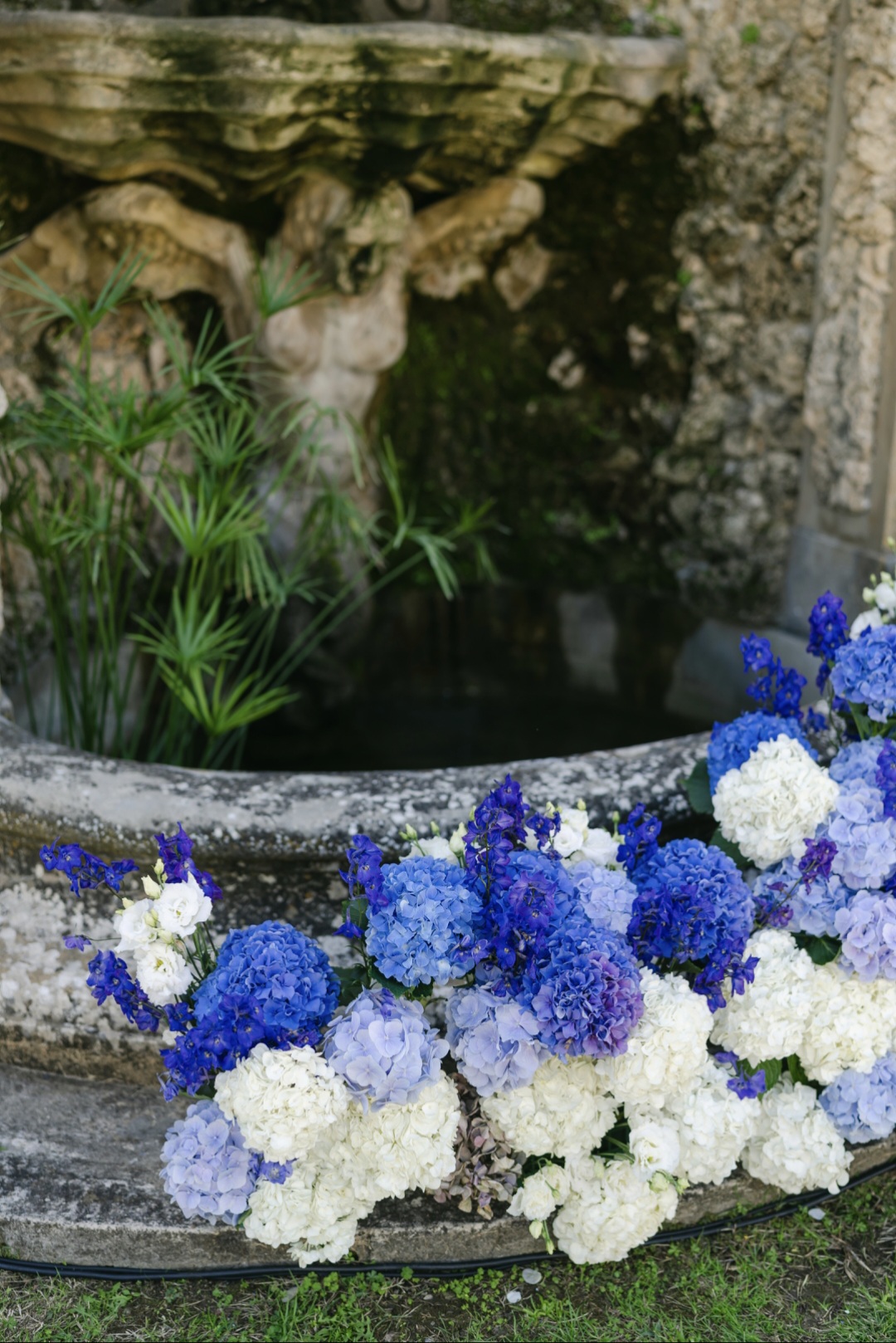 ceremony flower arrangements at historic fountain in Villa Medicea di Lilliano Tuscany